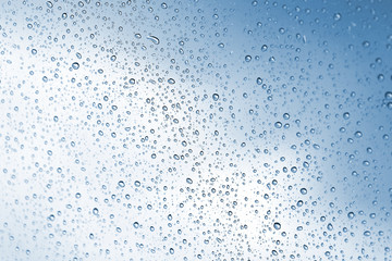 Rainy water drop on glass mirror background.
