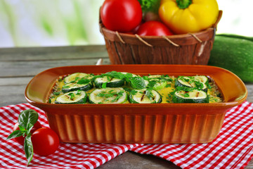 Casserole with vegetable mallow on wooden table table on light background
