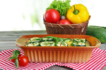 Casserole with vegetable mallow on wooden table table on light background