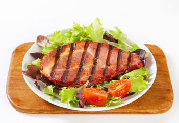 Grilled pork with salad greens