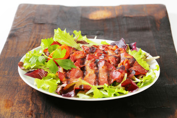 Grilled pork meat with salad greens