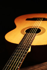 Acoustic guitar on dark background