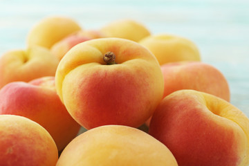 Heap of ripe apricots on wooden table close up