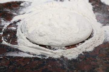 Preparing pizza dough on marble table, closeup