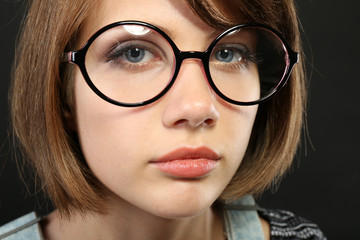 Attractive young woman with glasses close up