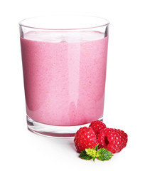 Glass of raspberry milk shake on light background