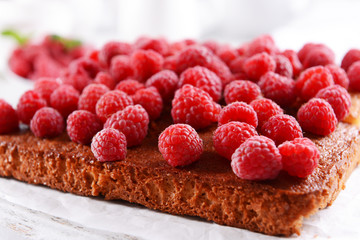 Fresh pie with raspberry on wooden tray, closeup