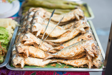 fried mackerel on tray for sell in the market