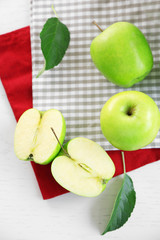 Green apples on table with napkins, closeup
