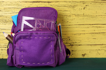 School backpack on wooden background