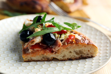 Pieces of homemade pizza on plate, close-up