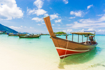 Fototapeta na wymiar Longtail wood boat and islands in andaman sea