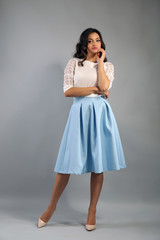 Young pretty woman on grey background