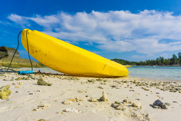 Colorful yellow kayaks on beach in Andaman sea
