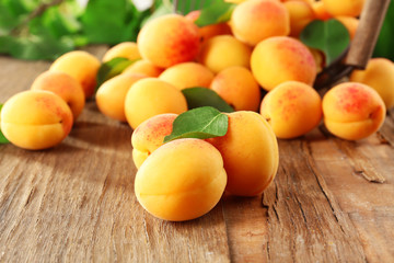 Naklejka na ściany i meble Ripe apricots on wooden table, closeup