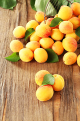 Naklejka na ściany i meble Ripe apricots on wooden background