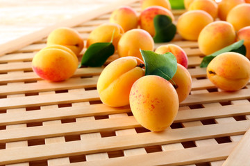 Ripe apricots on wooden lattice background