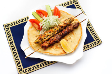 Souvlaki or kebab, grilled meat on pita bread with tomatoes and