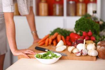 Young woman cutting vegetables in the kitchen