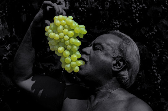 Man Eating White Grapes