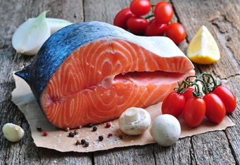 raw salmon steak with cherry tomato, mushroom, onions, dill, garlic, lemon and olive oil