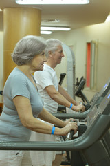 Senior couple exercising in gym