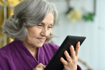 Old woman with tablet pc