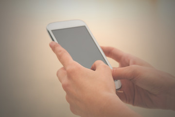 Texting on a smartphone. Shallow depth of field.