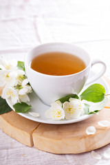 Jasmine tea in a cup with fresh flowers