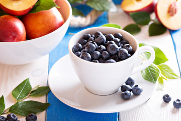 Fresh blueberries in a white cup
