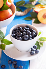Fresh blueberries in a white cup