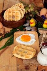 Sweet waffles and fresh milk with jam and egg heart.