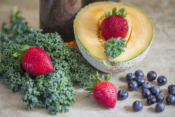 Healthy smoothie with berry fruit,cantaloupe and green kale.
