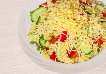 pasta salad with cheese, tomato and cucumber