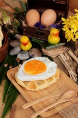 Sweet waffles and fresh milk with jam and egg heart.