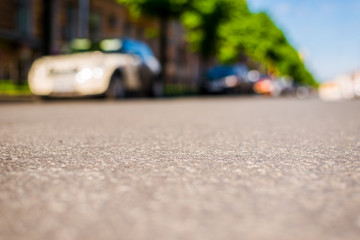 City on a sunny day, a quiet street with trees and cars