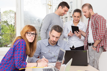 Young group of people discussing business plans.