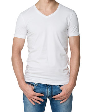 Young man in a white V shape t-shirt, hands in pockets. Isolated.