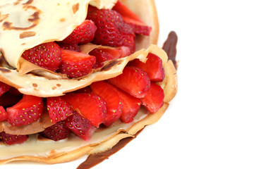 served dessert: isolated pancakes with strawberry and chocolate
