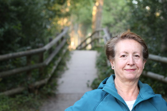 Elder woman walking through the countryside