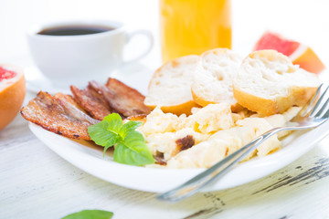 Scrambled eggs with bacon, breakfast