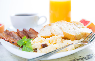 Scrambled eggs with bacon, breakfast