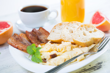 Scrambled eggs with bacon, breakfast