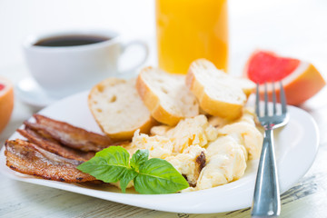 Scrambled eggs with bacon, breakfast