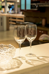 Simple home table setting, glasses in the kitchen interior.