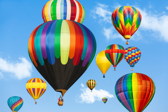 Colorful hot air balloons against blue sky. 