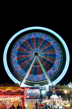 Colorful ferris wheel in motion at night