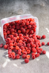 Ripe raspberries scattered on the table