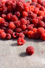 Ripe raspberries scattered on the table