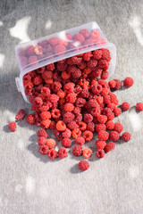 Ripe raspberries scattered on the table